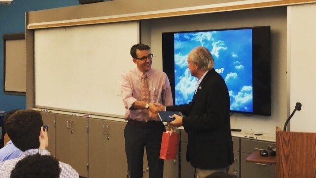 Teacher Scott McComb thanks Rodrigo Huete for being the featured speaker for the evening, and presents Rod with a few small gifts.