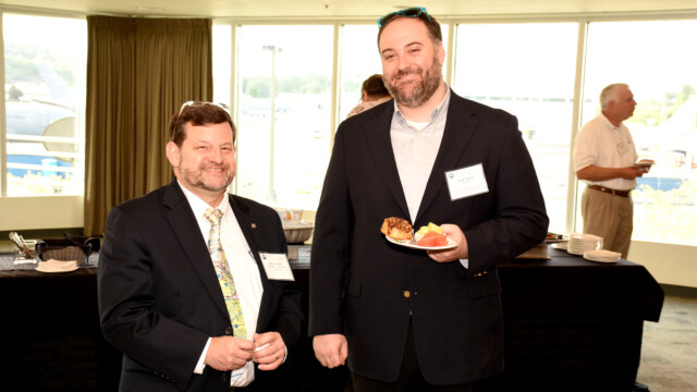 Pete Donath and Noah Aaron enjoy some breakfast before the Symposium starts.