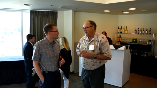 Tyler Wilson and Henry Stahl enjoy a cocktail at the reception following the Friday Symposium.