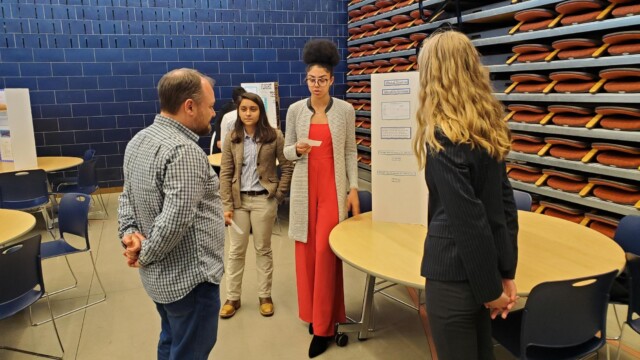 Flight Test Engineer Ted Schumacher listens as students present their test results.